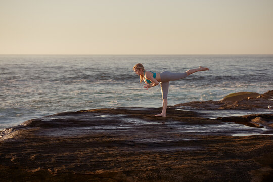 Woman Doing Yoga By The Ocean