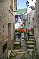 A narrow street between the old houses of Petina, a village in the mountains of Salerno province,...