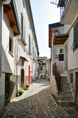A narrow street between the old houses of Petina, a village in the mountains of Salerno province, Italy.