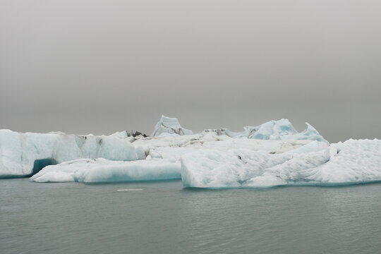 Melting blue ice rocks floating in glacier lake of Jokulsarlon, Iceland