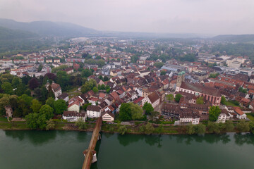 Fototapeta na wymiar Aerial view of City Bad Säckingen, Baden-Württemberg, with covered wooden bridge on a cloudy spring day. Photo taken May 6th, 2022, Bad Säckingen, Germany.