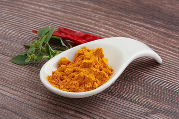 Yellow vibrant curcuma powder in the bowl