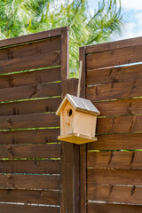 Birdhouse on wooden fence - selective focus