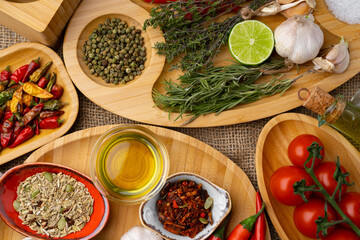 Close up of wooden board with spices, herbs and cooking ingredients