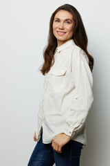 portrait of a beautiful happy attractive adult woman in a white shirt on a white background