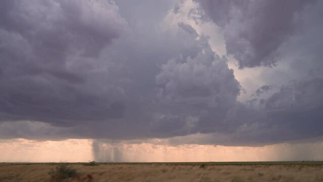 View of rainstorm in West Texas from vehicle while storm chasing moving in slow motion.