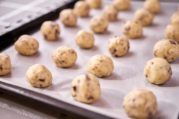 baking tray full of raw dough ball while making Chocolate chip cookies