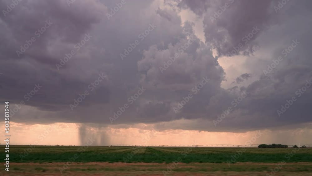 Canvas Prints view from vehicle driving down road looking at rainstorm in the distance while storm chasing in texa