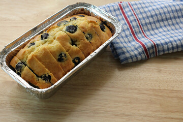 Blueberry Muffin Cake in Loaf Pan on wooden tabletop with napkin