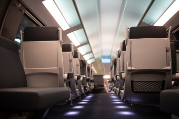 Empty comfortable modern seats inside business class cabin of fast speed European train. Interior of high speed train compartment.