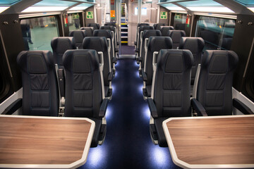 Empty comfortable modern seats inside business class cabin of fast speed European train. Interior...
