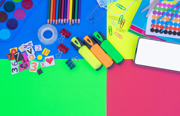 Back to school - colorful background, pencils, notebooks, scissors and accessories - education concept, copy space