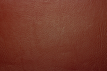 Photo of the texture of red leather fabric. Leather background for text. The texture of genuine leather.
