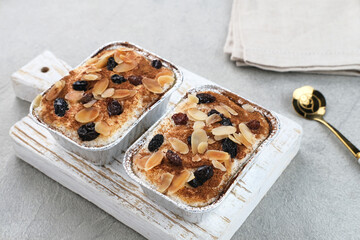 Klappertaart is one of indonesian traditional dessert, from Manado. Coconut custard cake with raisin and almond topping, dusted with cinnamon powder, Dutch influenced dessert. 