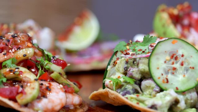 Mexican corn seafood tostadas spinning in a wood table tacos