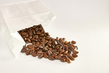 Coffee beans fell out of the paper bag. Food packaging.