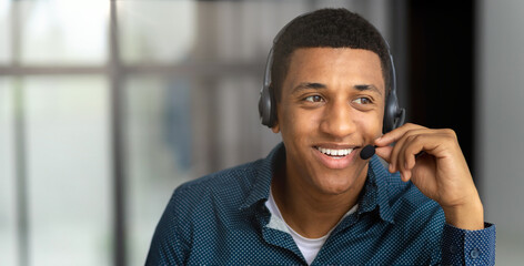 Portrait of African american young male customer support call center operator or receptionist