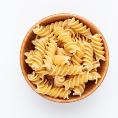 Whole fusilli pasta in a wooden bowl.