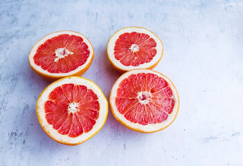 Cut  grapefruits  on a gray textured background 