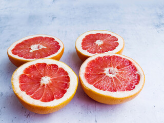 Cut  grapefruits  on a gray textured background 