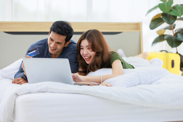Asian happy romantic male female husband and wife lover couple lay down smiling together on pillow...