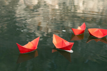 paper red ships on the river