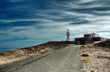 road that takes us to the beautiful lighthouse of the town of Arinaga on the island of Gran Canaria Spain - 508590749