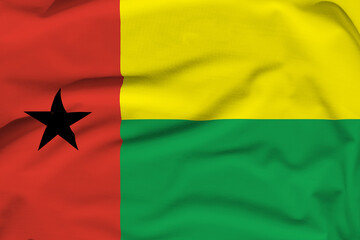 Guinea-Bissau national flag, folds and hard shadows on the canvas