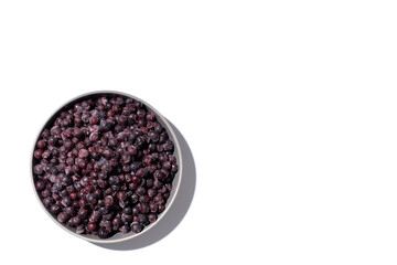 Frozen Blueberries Piled in a Heap in a bowl on a Summer Day Isolated on White Top View Room for Copy