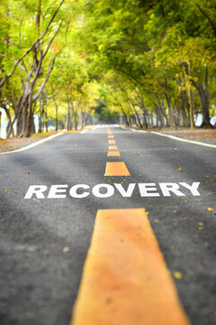 Recovery written on road. Positive journey concept and empower idea