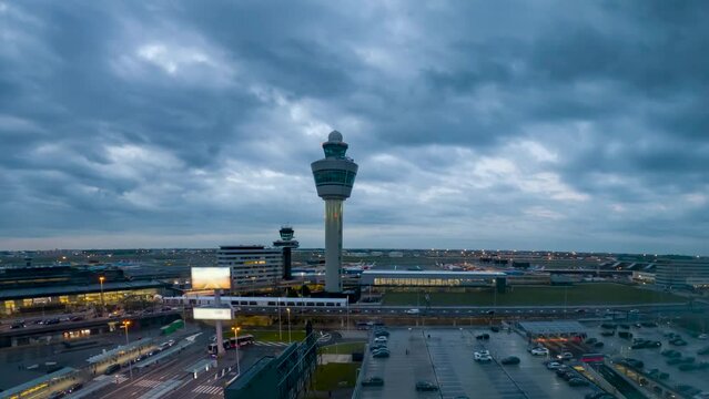 Nighttime at the Schiphol International Airport in Amsterdam and air traffic control tower - time lapse