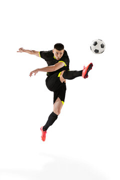 Professional male football soccer player in motion and action isolated on white studio background. Concept of sport, goals, competition, hobby, world cup