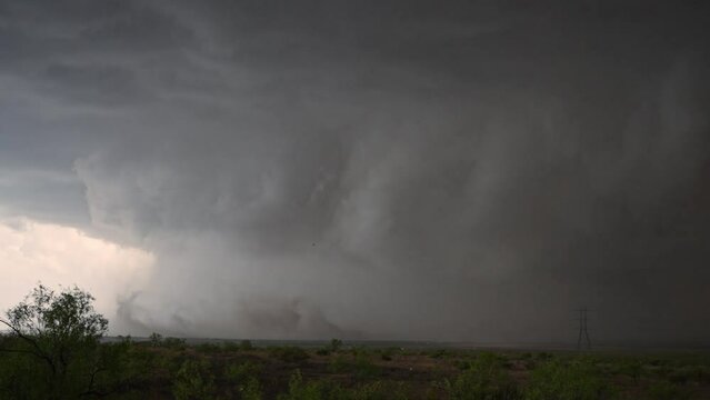 Dust blowing in front of supercell storm moving through Texas turning day into night.
