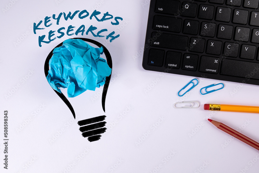 Poster keywords research. abstract light bulb and computer keyboard on a white background