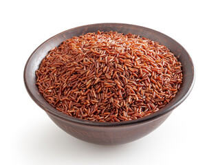 Uncooked red rice in ceramic bowl isolated on white background with clipping path