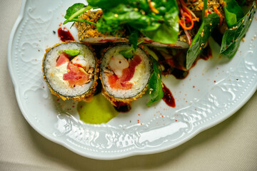Spicy maguro salad with mix of greens, tuna, cucumber, avocado, cherry tomato, soy sprouts, kimchi sauce, narsharab sauce, lemon, microgreen isolated on black