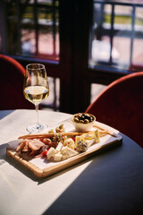 Background of salami, smoked sausage and assortment of cheese. On a black stone background. Free space for your text.