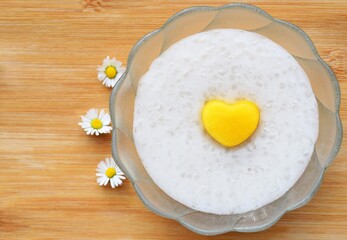 Homemade tapioca pudding with coconut milk, decorated with fresh nectarine in a shape of heart. Romantic concept, inspiration