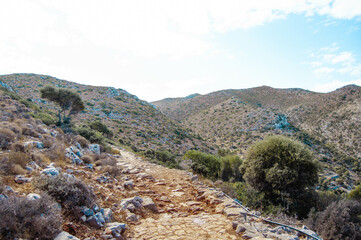Paved stone path among the hills, Crete island, Greece.