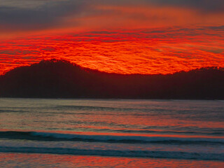 Fototapeta na wymiar Cloud filled winter sunrise sky at the beach