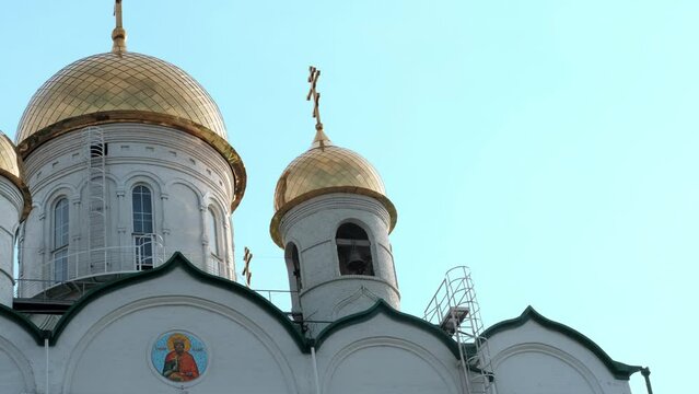 Fragment of the Orthodox Church exterior with golden domes and crosses against the sky. Church of St. John the Evangelist, Barnaul, Russia