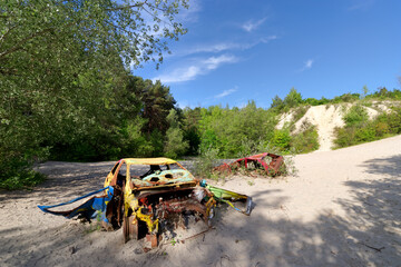 Old wreck car and sand dunes in the French Gatinais Regional Nature Park