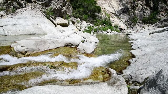 Rushing river of Travu (or Travo) near the village of Chisa, fresh water stream flowing on rock. Chisa, Corsica, France