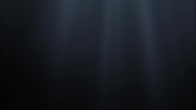 Seamless loop video. Light rays in dark underwater ocean abyss on background darkness. Magical deep ocean waves. Sun light beams illuminating ocean depths. 4K 3D abstract light motion titles cinematic