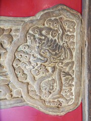 The dragon pattern is made of metal on the red door.