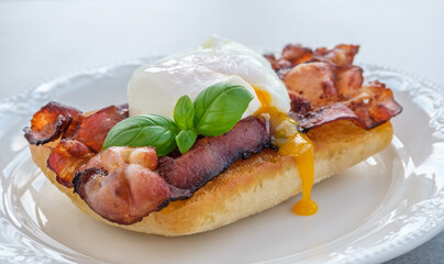 Sandwich with poached egg and bacon