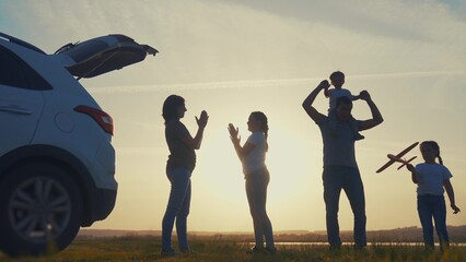 happy family car travel concept. people in the park playing on vacation picnic clap their hands....