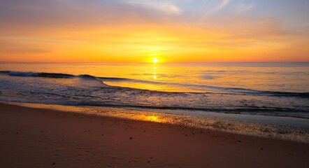 beautiful bright sunset at the ocean, empty beach, sunlight 