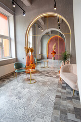 interior of a large apartment in oriental mixed with loft style with arches, led lighting and bright orange elements