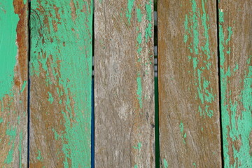 Old wooden background has peeling paint.